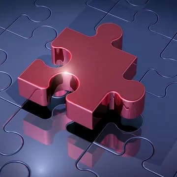 A red piece of a puzzle. Looks like the last piece hovering above its final location. Underneith you can see the rest of the puzzle in blue color, already pieced together. 